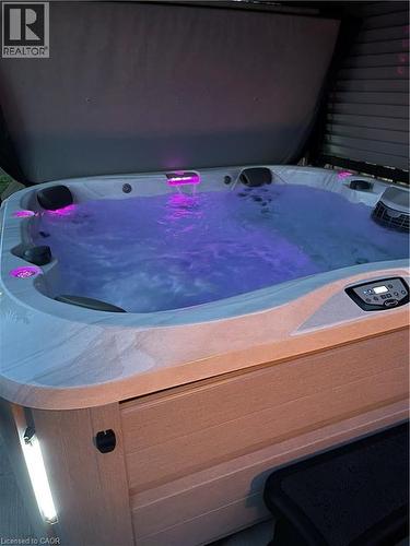The property includes a hot tub with illuminated water features and integrated exterior lighting - 420 Waverly Street, Hamilton, ON - 