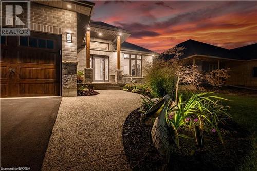 View of front of home with stone siding and driveway - 11 Sycamore Drive, Port Dover, ON - Outdoor