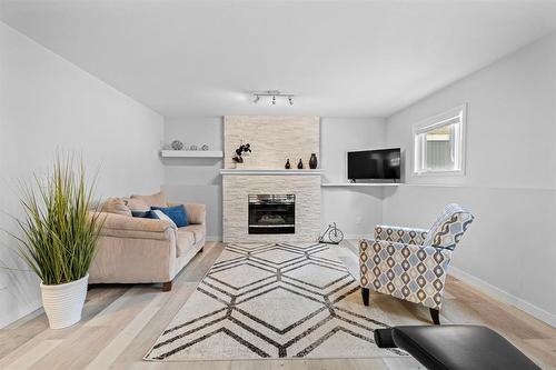 180 De La Seigneurie Boulevard, Winnipeg, MB - Indoor Photo Showing Living Room With Fireplace