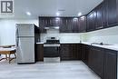 Kitchen featuring stainless steel appliances, light countertops, light wood-type flooring, recessed lighting, and dark wood finish cabinets - 59 Windrush Trail S Unit# B, Kitchener, ON  - Indoor Photo Showing Kitchen 