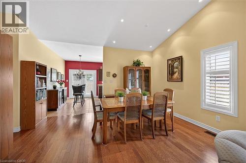 Dining area with dark wood-style flooring, hanging lights, and vaulted ceiling - 48 Hallmark Trail, Hamilton, ON - Indoor Photo Showing Dining Room