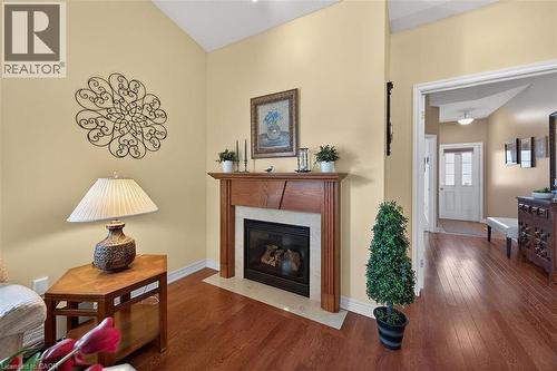 Living area featuring dark wood-style floors and a fireplace - 48 Hallmark Trail, Hamilton, ON - Indoor Photo Showing Living Room With Fireplace