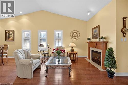 Living area with a premium fireplace, hardwood / wood-style flooring, and vaulted ceiling - 48 Hallmark Trail, Hamilton, ON - Indoor Photo Showing Living Room With Fireplace