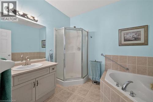 Bathroom featuring vanity, a garden tub, a shower stall, and light tile patterned flooring - 48 Hallmark Trail, Hamilton, ON - Indoor Photo Showing Bathroom