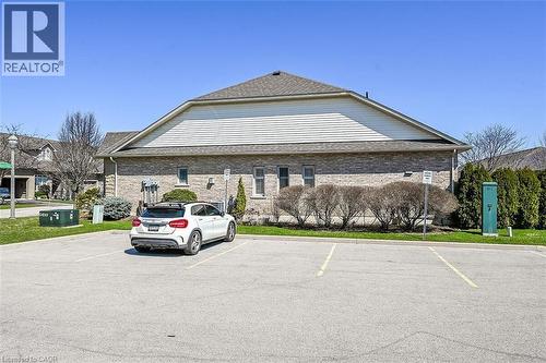View of building exterior featuring uncovered parking - 48 Hallmark Trail, Hamilton, ON - Outdoor