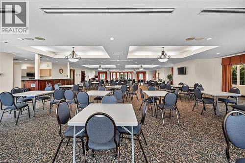 Carpeted dining room with a tray ceiling and recessed lighting - 48 Hallmark Trail, Hamilton, ON - Indoor