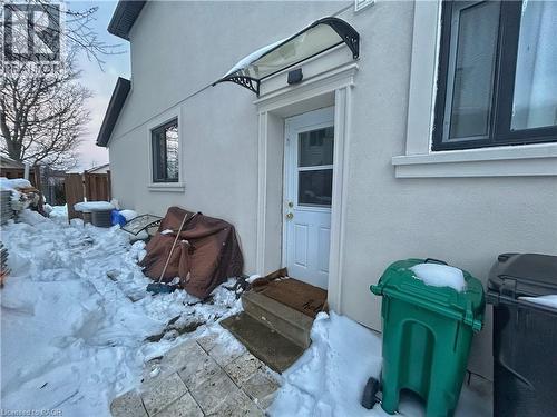 Snow covered property entrance with stucco siding - 206A Springfield Crescent Unit# Lower, Waterloo, ON - Outdoor With Exterior