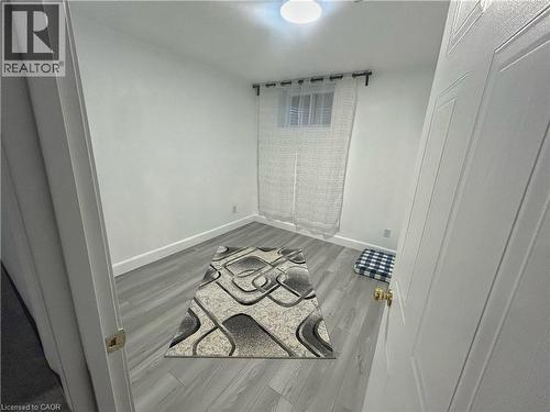 Unfurnished room featuring light wood-style flooring and baseboards - 206A Springfield Crescent Unit# Lower, Waterloo, ON - Indoor
