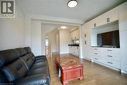 Living room with light wood-style floors and baseboards - 