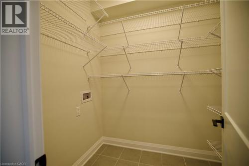 Laundry room featuring hookup for a washing machine and tile patterned flooring - 559 Balsam Poplar Street, Waterloo, ON - Indoor With Storage