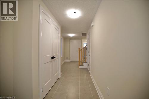 Hall featuring a textured ceiling and light tile patterned floors - 559 Balsam Poplar Street, Waterloo, ON - Indoor Photo Showing Other Room