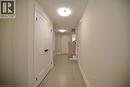Hall featuring a textured ceiling and light tile patterned floors - 559 Balsam Poplar Street, Waterloo, ON  - Indoor Photo Showing Other Room 