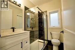 Bathroom with vanity and a marble finish shower - 