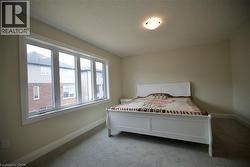 Carpeted bedroom featuring baseboards and a textured ceiling - 