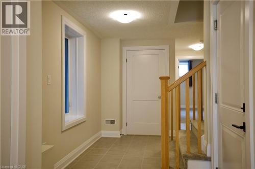 Foyer with a textured ceiling and light tile patterned flooring - 559 Balsam Poplar Street, Waterloo, ON - Indoor Photo Showing Other Room