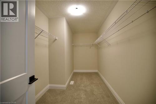 Walk in closet featuring light carpet - 559 Balsam Poplar Street, Waterloo, ON - Indoor With Storage