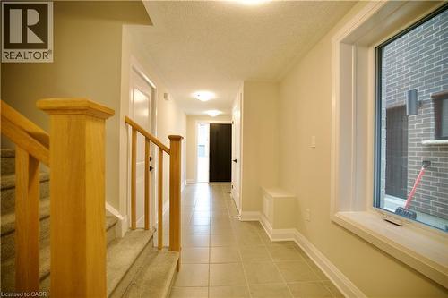 Hall featuring a textured ceiling and light tile patterned floors - 559 Balsam Poplar Street, Waterloo, ON - Indoor Photo Showing Other Room