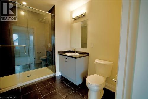 Full bathroom with vanity, a stall shower, and dark tile patterned floors - 559 Balsam Poplar Street, Waterloo, ON - Indoor Photo Showing Bathroom