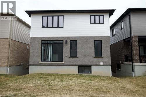 Back of house with a yard and brick siding - 559 Balsam Poplar Street, Waterloo, ON - Outdoor With Exterior