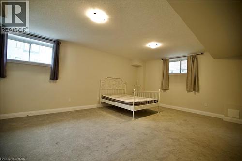 Unfurnished bedroom with carpet floors and a textured ceiling - 559 Balsam Poplar Street, Waterloo, ON - Indoor