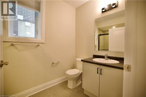 Bathroom featuring vanity, light tile patterned floors, and a shower with shower door - 559 Balsam Poplar Street, Waterloo, ON - Indoor Photo Showing Bathroom