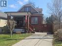 Bungalow-style house with brick siding, a front lawn, a gate, and covered porch - 253 Grosvenor Avenue S, Hamilton, ON  - Outdoor 