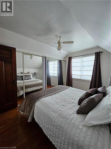 Bedroom with dark wood finished floors, vaulted ceiling, and a ceiling fan - 253 Grosvenor Avenue S, Hamilton, ON - Indoor Photo Showing Bedroom