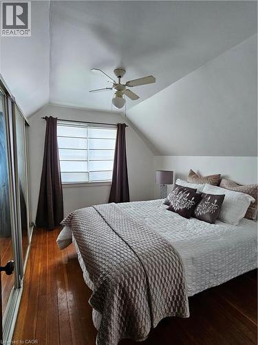Bedroom featuring dark wood-type flooring, a ceiling fan, and a closet - 253 Grosvenor Avenue S, Hamilton, ON - Indoor Photo Showing Bedroom
