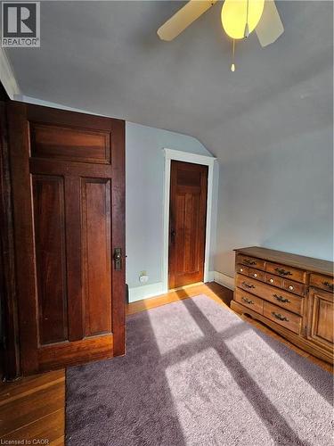 Unfurnished bedroom with vaulted ceiling, ceiling fan, and dark wood-style floors - 253 Grosvenor Avenue S, Hamilton, ON - Indoor Photo Showing Other Room