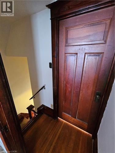 Staircase featuring hardwood / wood-style floors - 253 Grosvenor Avenue S, Hamilton, ON - Indoor Photo Showing Other Room