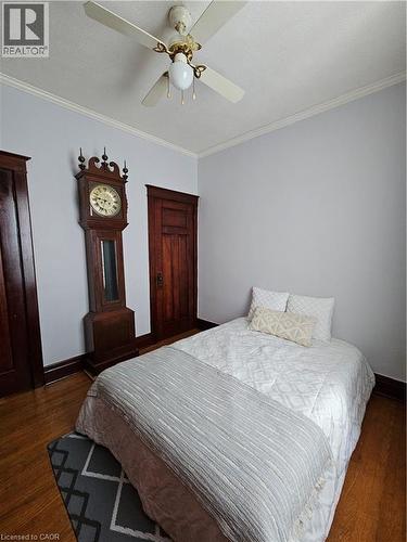 Bedroom featuring ornamental molding, dark wood-style flooring, and ceiling fan - 253 Grosvenor Avenue S, Hamilton, ON - Indoor Photo Showing Bedroom