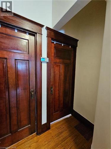 Hall featuring dark wood-style flooring and baseboards - 253 Grosvenor Avenue S, Hamilton, ON - Indoor Photo Showing Other Room