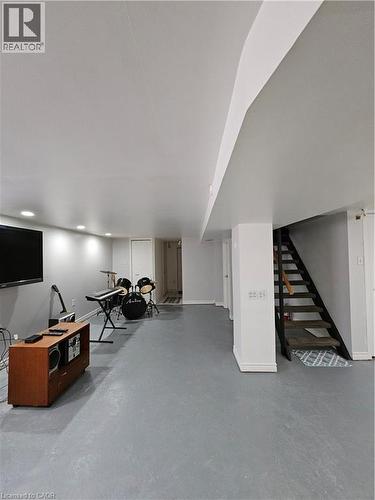 Finished basement with stairway and baseboards - 253 Grosvenor Avenue S, Hamilton, ON - Indoor Photo Showing Other Room