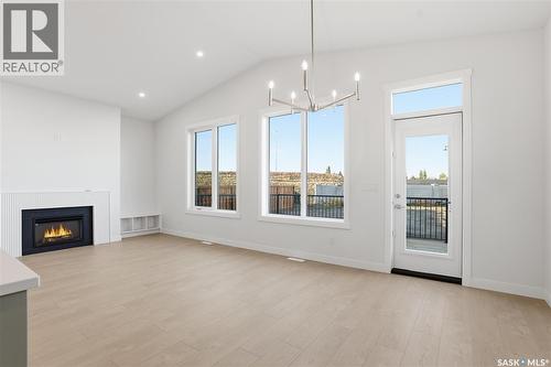 151 Nazarali Way, Saskatoon, SK - Indoor Photo Showing Other Room With Fireplace