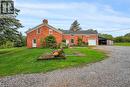 View of front of home featuring a chimney, driveway, a garage, a front lawn, and brick siding - 2432 Seburn Road, Fonthill, ON  - Outdoor 