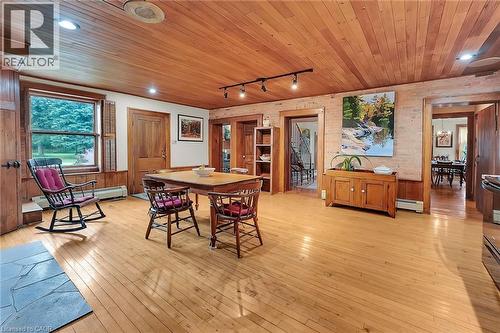 Dining room with wooden walls, rail lighting, light wood-style flooring, a baseboard radiator, and wood ceiling - 2432 Seburn Road, Fonthill, ON - Indoor