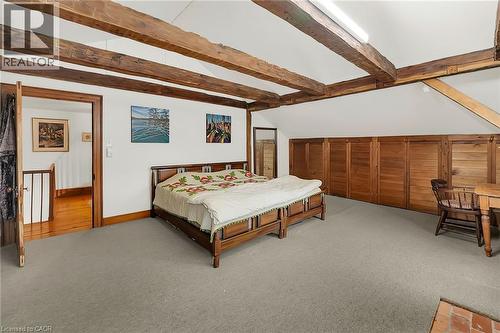 Bedroom with light carpet and vaulted ceiling with beams - 2432 Seburn Road, Fonthill, ON - Indoor