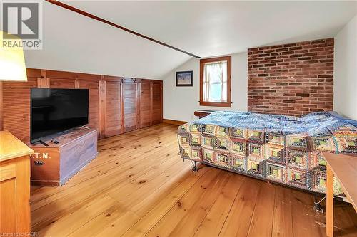 Bedroom with light wood finished floors, lofted ceiling, and brick wall - 2432 Seburn Road, Fonthill, ON - Indoor