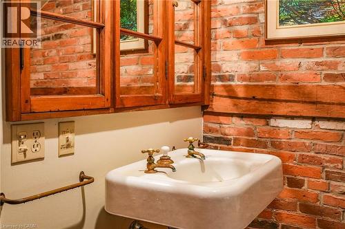 Bathroom with brick wall and a sink - 2432 Seburn Road, Fonthill, ON - Indoor Photo Showing Bathroom