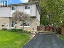 Front exterior of home featuring long paved driveway, and a front lawn - 1345 Colonsay Drive, Burlington, ON  - Outdoor 
