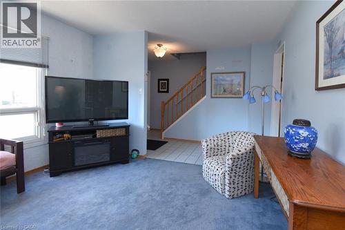 Carpeted living area, tiled foyer and hardwood stairway - 1345 Colonsay Drive, Burlington, ON - Indoor Photo Showing Living Room