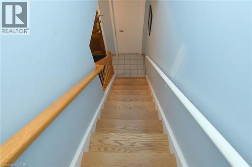 Coat closet in foyer and Stairway with wood finished floors leading to the upper level - 1345 Colonsay Drive, Burlington, ON - Indoor Photo Showing Other Room