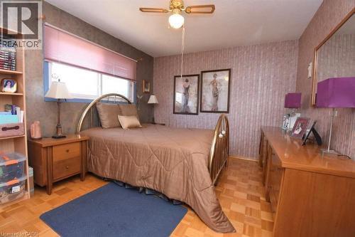 Bedroom with wallpapered walls, parquet floors, and a ceiling fan - 1345 Colonsay Drive, Burlington, ON - Indoor Photo Showing Bedroom