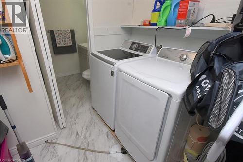 Laundry area featuring washing machine and clothes dryer and light marble finish flooring - 1345 Colonsay Drive, Burlington, ON - Indoor Photo Showing Laundry Room