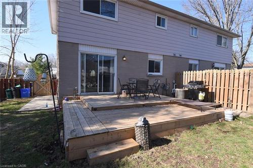 Rear view of house featuring a fenced backyard, outdoor dining area, and wooden deck - 1345 Colonsay Drive, Burlington, ON - Outdoor With Deck Patio Veranda With Exterior