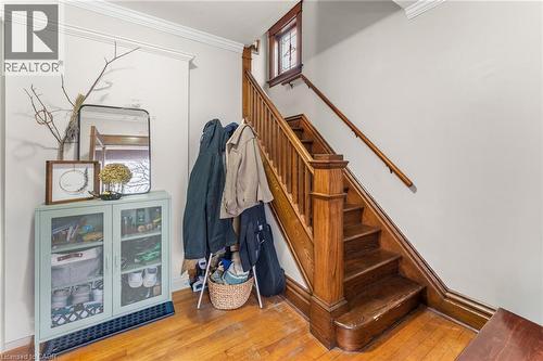 Stairway with hardwood / wood-style floors and ornamental molding - 58 Hohner Avenue, Kitchener, ON - Indoor Photo Showing Other Room