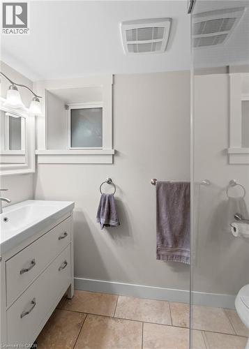 Bathroom featuring vanity, a shower stall, and light tile patterned floors - 58 Hohner Avenue, Kitchener, ON - Indoor Photo Showing Bathroom
