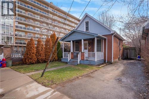 Bungalow featuring a porch, brick siding, a front lawn, and driveway - 6 Ben Lomond Place, Hamilton, ON - Outdoor
