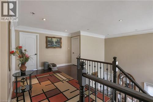 Hall with ornamental molding, an upstairs landing, dark wood-style flooring, and recessed lighting - 254 Rymal Road W, Hamilton, ON - Indoor Photo Showing Other Room