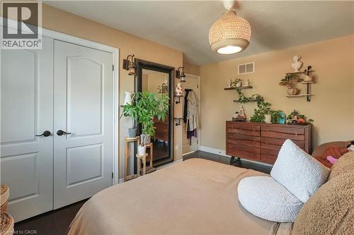 Bedroom featuring a closet and dark wood-type flooring - 254 Rymal Road W, Hamilton, ON - Indoor Photo Showing Bedroom